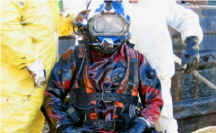 Viking HD Commercial Diving Drysuit | The Viking Heavy-Duty HD 1500 and Heavy-Duty HD 1500 Wide vulcanized rubber dry suits have strong reinforcements on the shoulders, crotch and legs to withstand the wear and tear of the equipment used. Commercial divers use a wide range of straps and harnesses. The dimensions of the wide models are designed to meet the demands of commercial divers, and the long heavy-duty zipper makes the suit easy to don. Many hood options (latex, neoprene, and rubber) and yokes (for Aquadyne, Comex, Desco, Draeger, Miller, and Superlite helmets) are available for Viking HD 1500 drysuits. | Diver shown covered in crude oil
